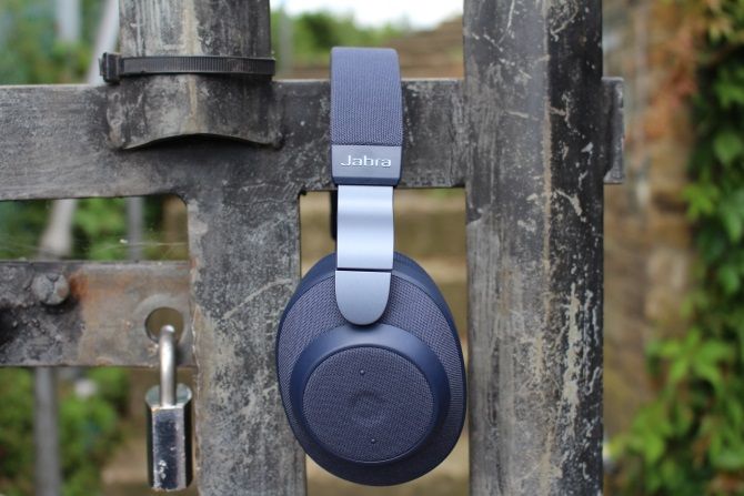 Jabra Elite 85h headphones on a locked gate