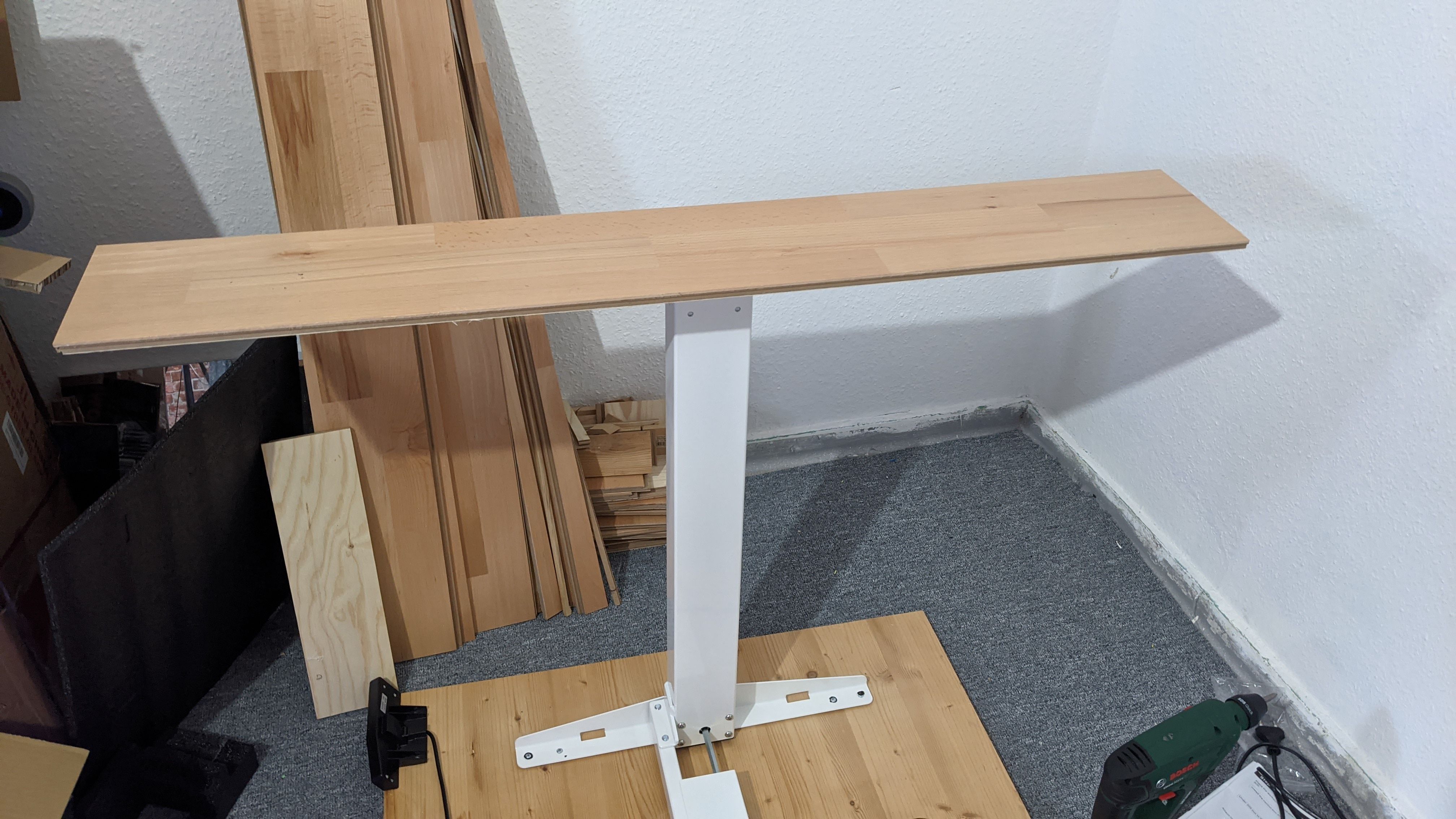Using a piece of wood to pre-level the desk