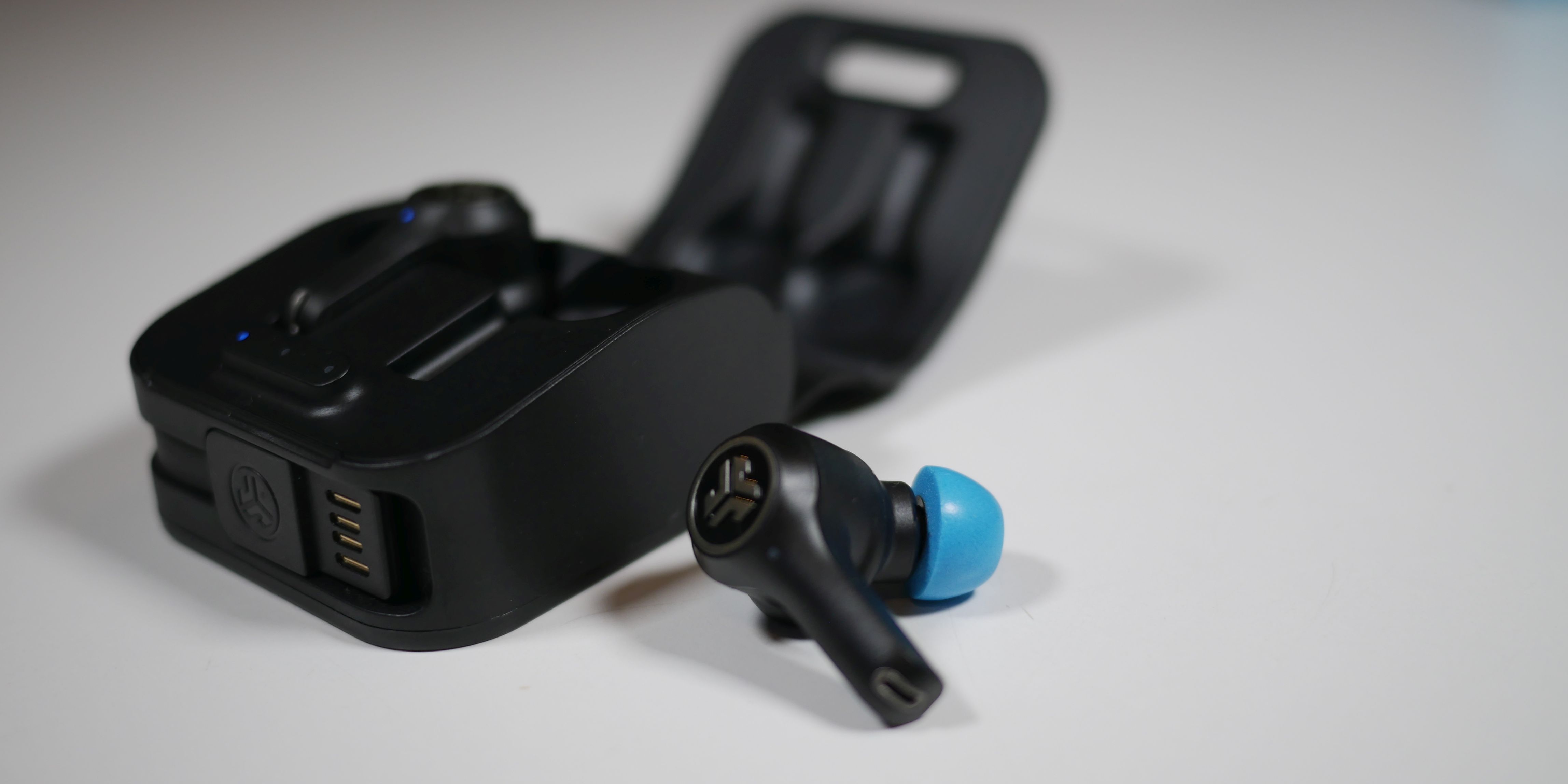 JLab Audio Epic Air ANC earphones charging in case with one earbud up close