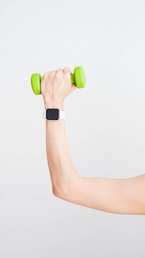Apple Watch on arm Holding Dumbell