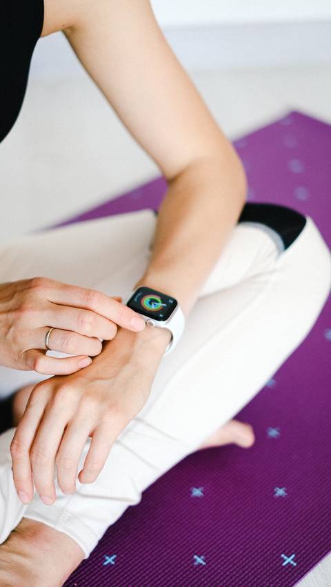 Woman on Yoga Matt w/ Apple Watch