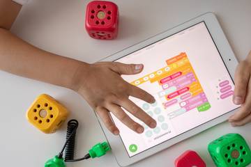 Photo of a kid learning on an iPad