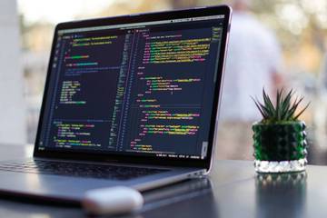 Laptop on Desk Showing Code