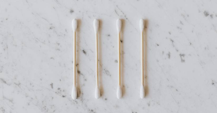 row of four cotton swabs