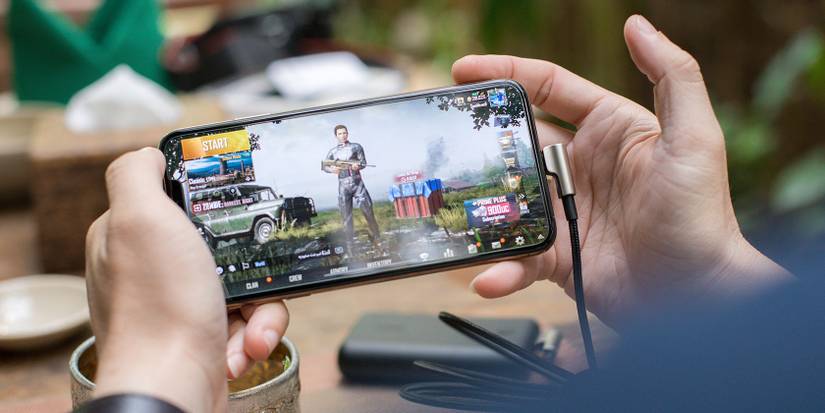Man Holding Smartphone Gaming