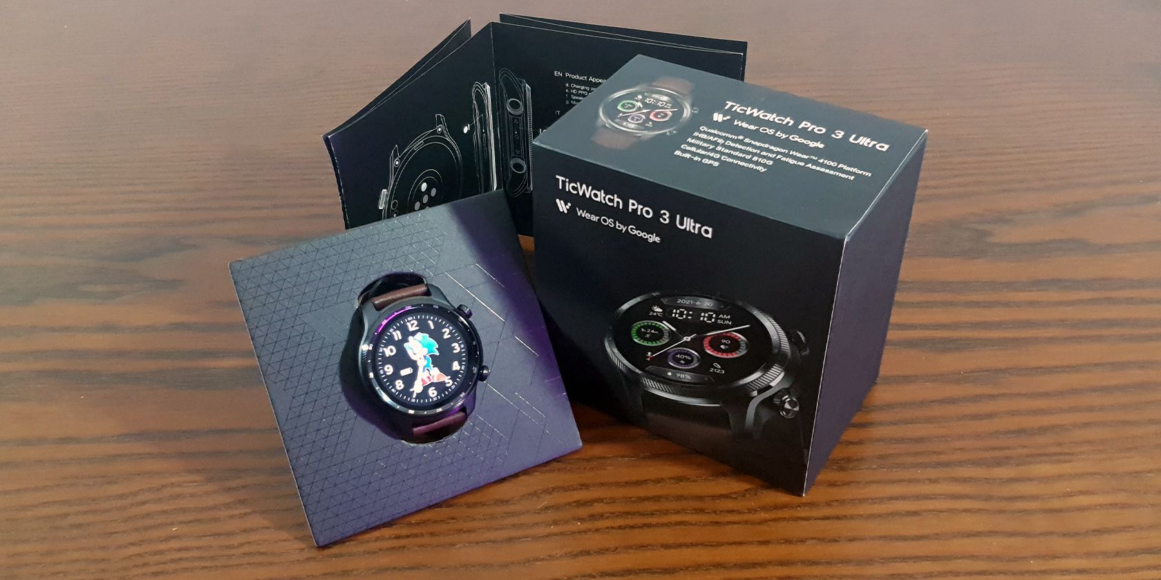 TicWatch Pro 3 Ultra GPS With Box and Manual on Wooden Surface