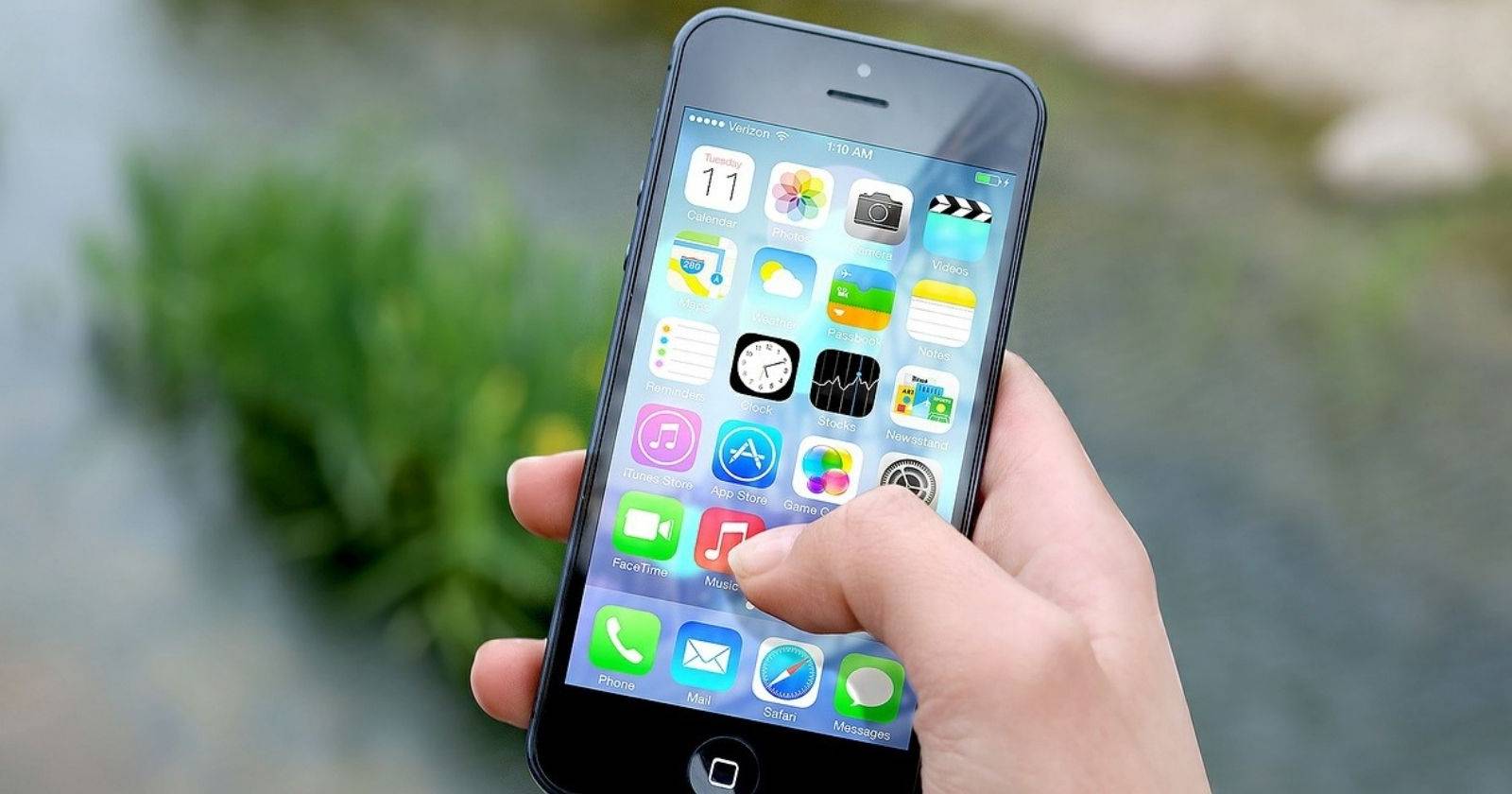 An iPhone user tapping onto the Music app.