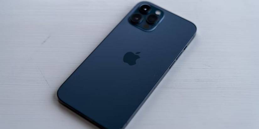 blue iphone pro on white surface