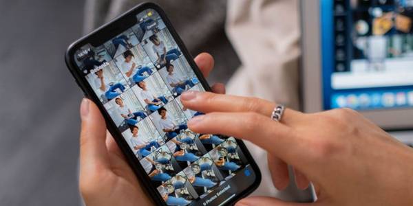 person's fingers swiping over recents photo album on iphone 