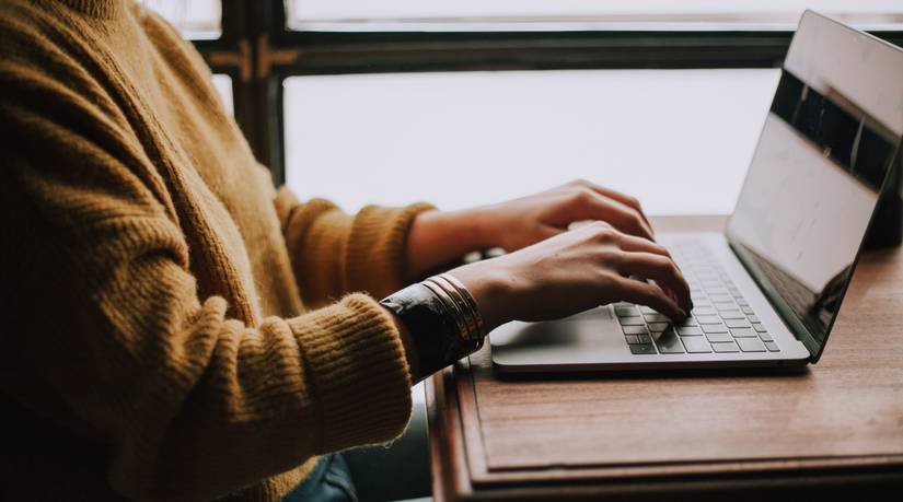 Person typing on a Windows laptop