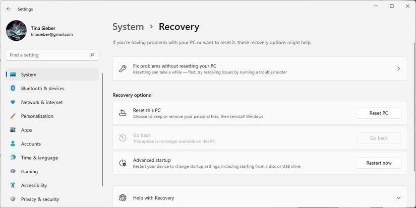 Windows 11 Settings menu with System > Recovery window open.