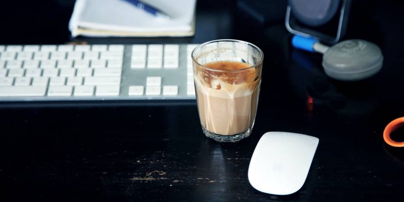 A cup of tea next to a keyboard