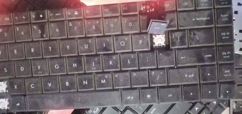 Keyboard with a broken key and the keyboard is covered with dirt