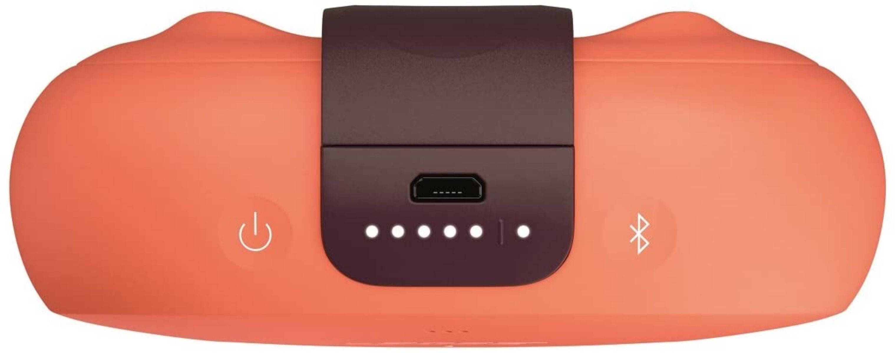 Bose SoundLink Micro lying flat showing the buttons and port on the bottom of orange speaker