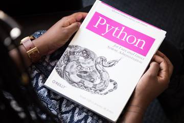 Woman holding a Python book in her hands