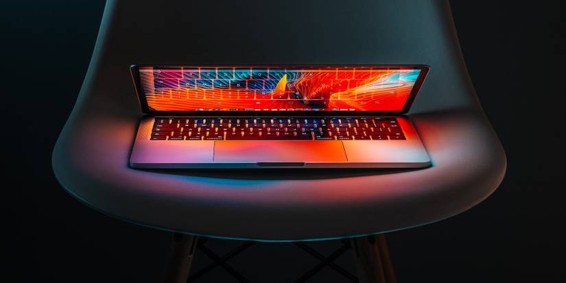 A half open macbook on a chair