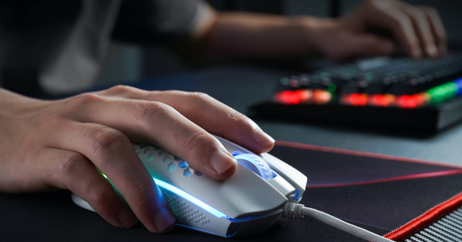 Man clicking mouse on table