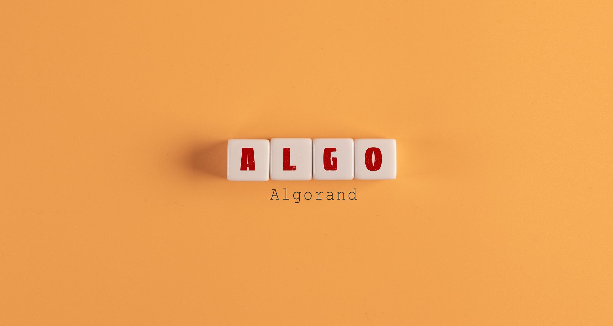 Algo written in Scrabble letters on an orange background