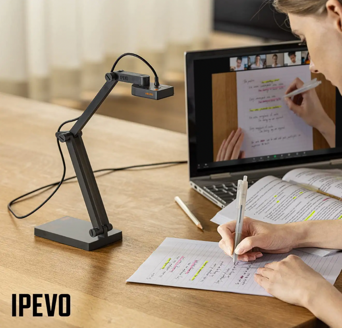 A female teacher using an IPEVO V4K Document Camera to scan a student's work