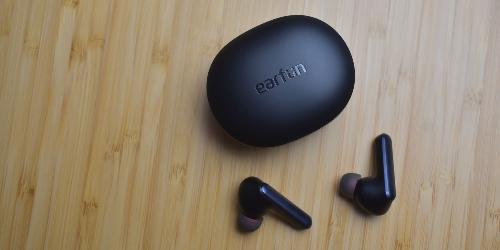 earfun air s earbuds in fron of case top down
