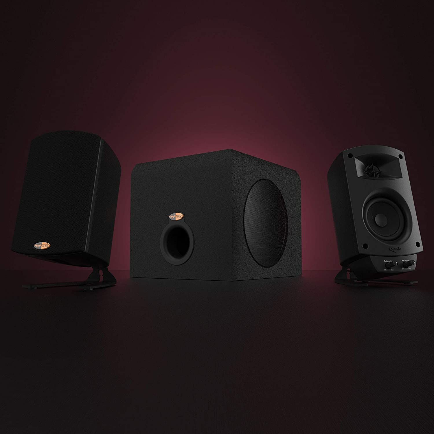 klipsch promedia 2.1 thx speakers against a maroon background