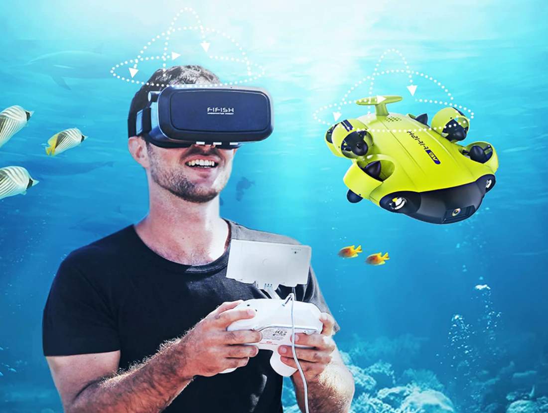 A man using the FiFish V6 VR headset with an oceanic background