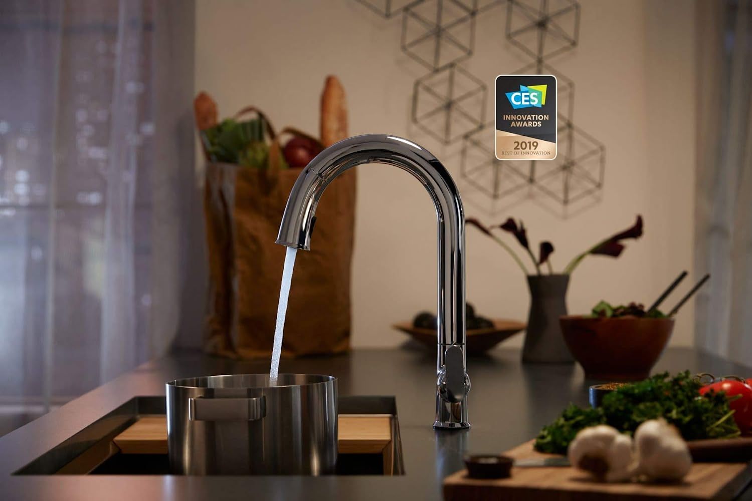 the kohler sensate smart kitchen faucet dispensing water into a pot