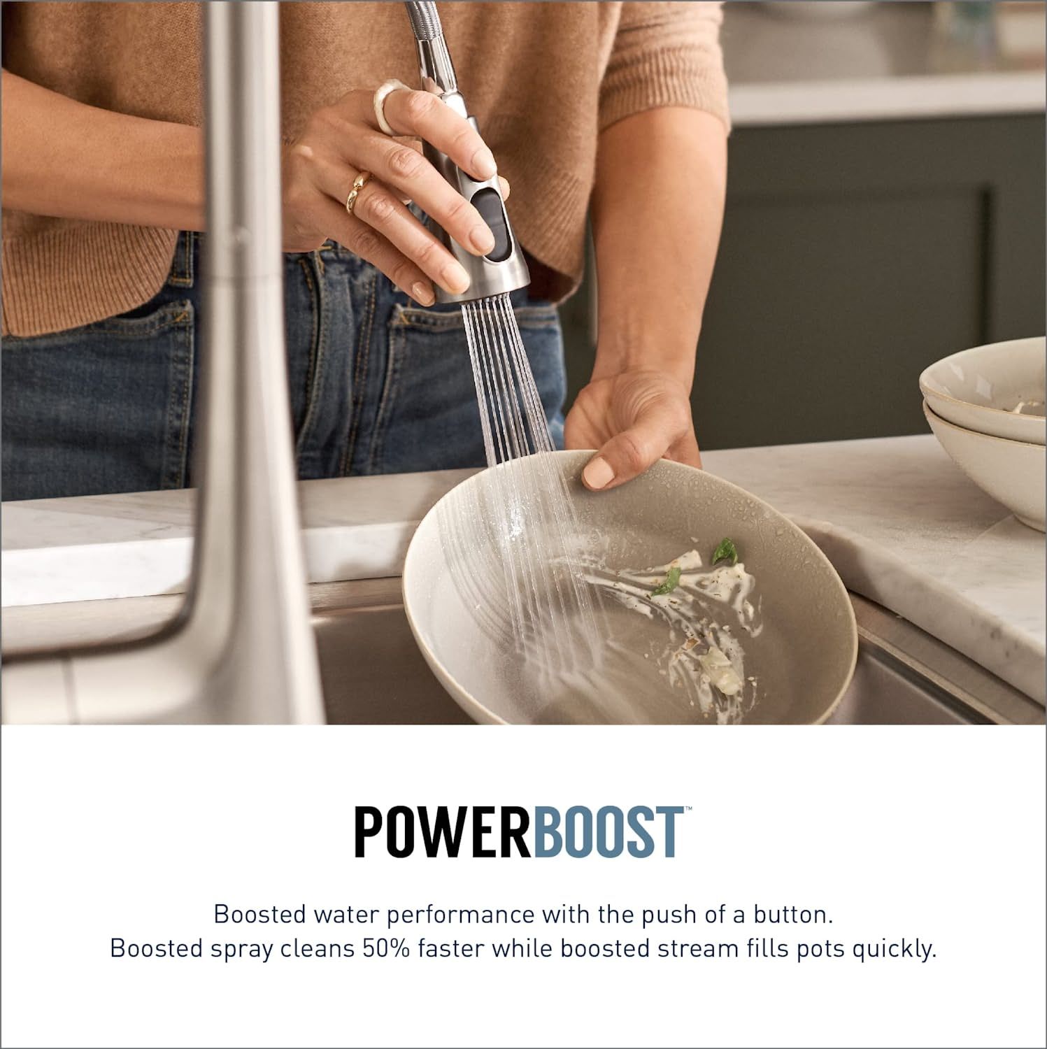 a person washing dishes with the moen sleek smart faucet