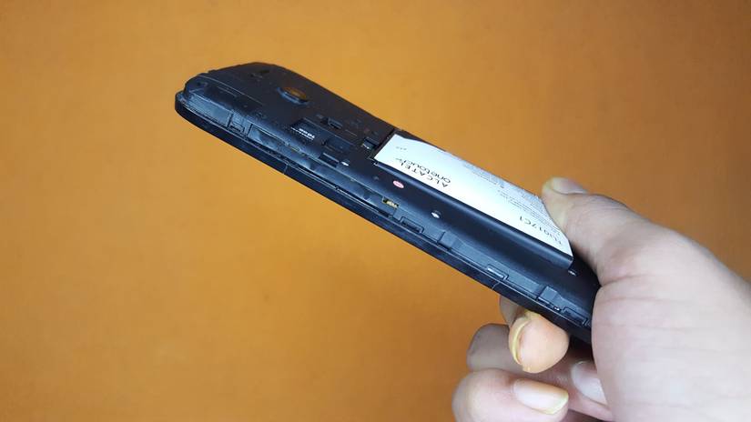 A swollen removable battery unable to fit inside the phone compartment