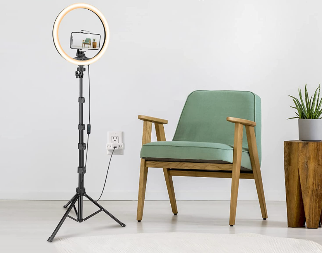 A Ubeesize 12-Inch Ring Light mounted on its tripod by chair