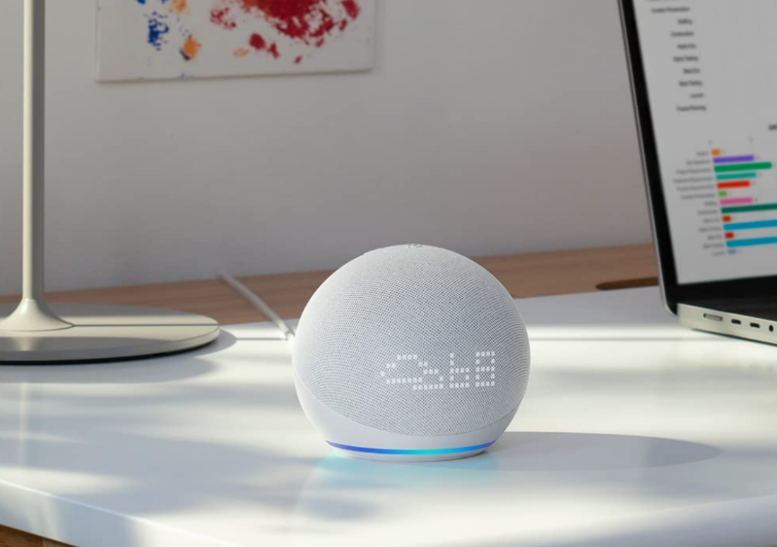 A shot of an Amazon Echo Dot (5th Gen) sitting on a desk.