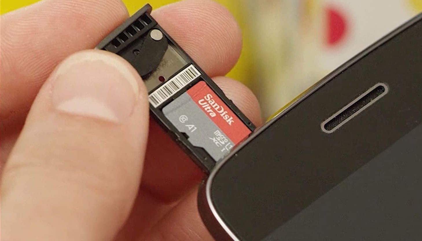 sandisk ultra being inserted into a phone