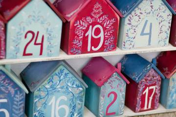 An advent calendar made from numbered wooden boxes painted red and blue.