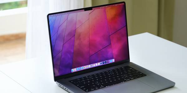 Apple MacBook Pro on a table in front of a window