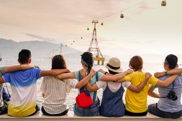 a group of friends sitting on a dock