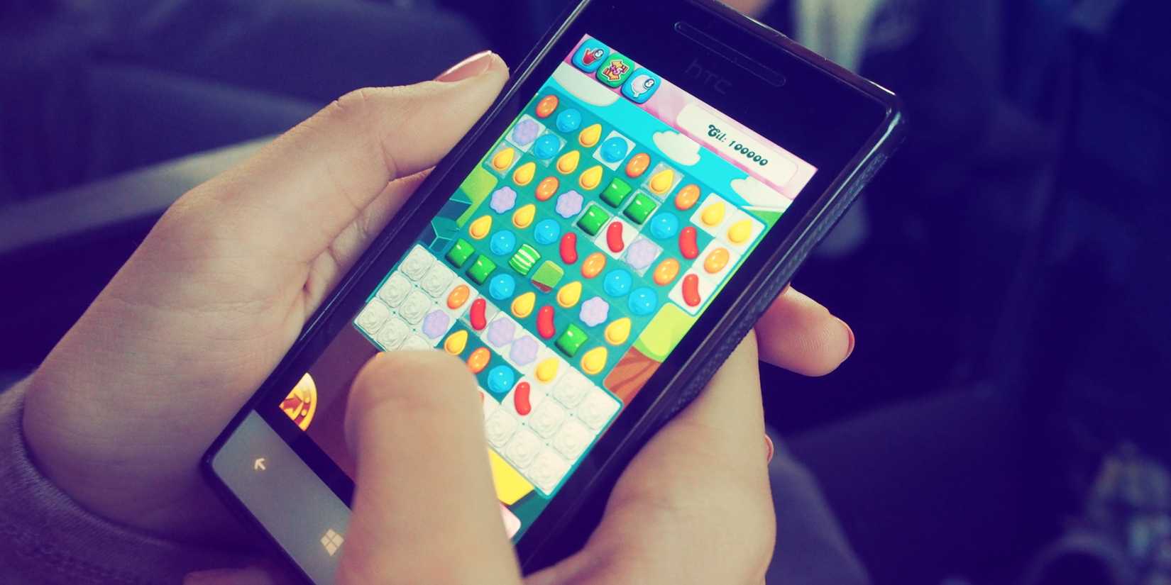 Person Playing Candy Crush on Nokia Photo