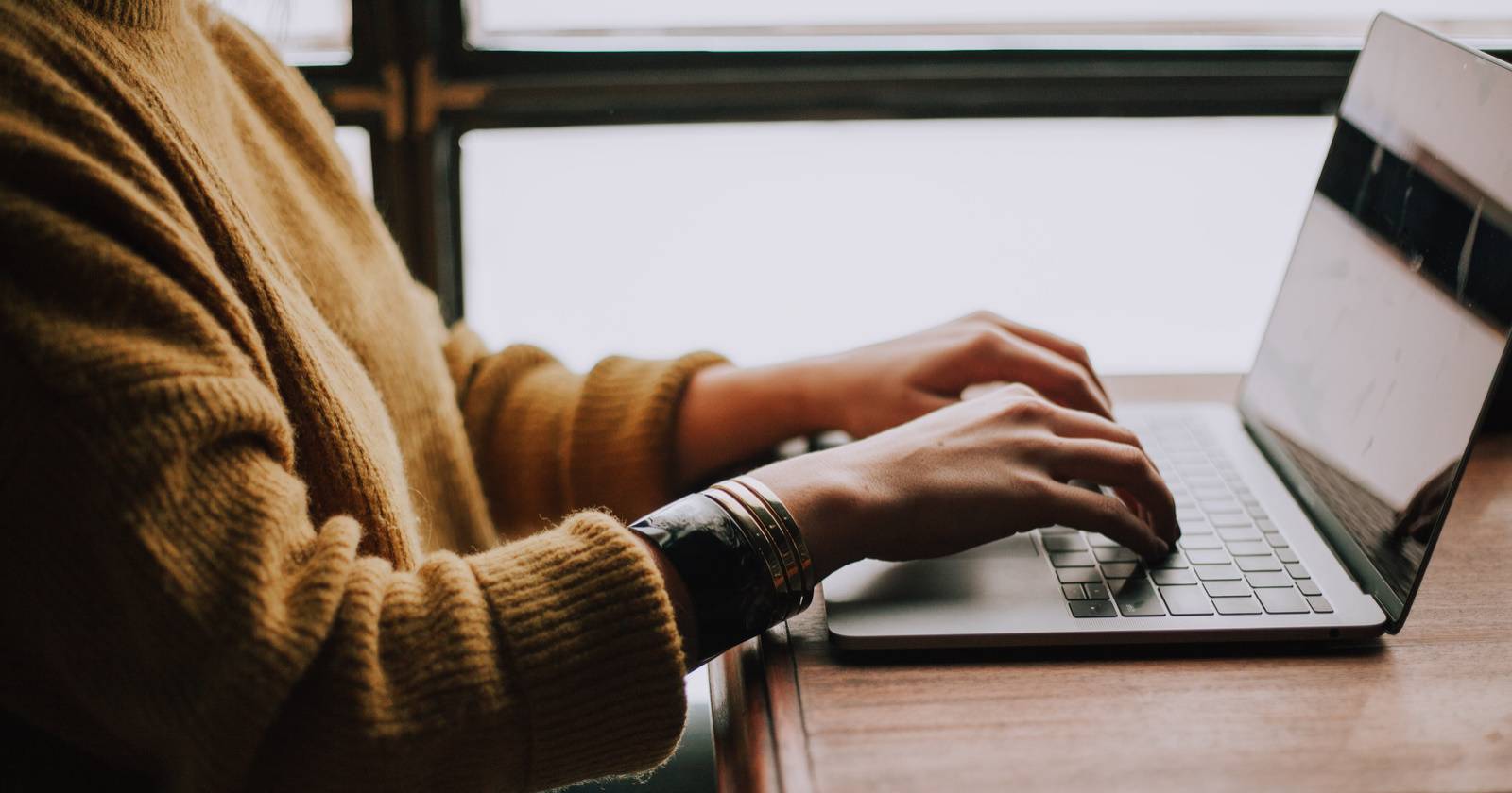 Photo of a person working on their laptop