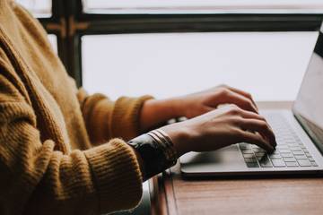 Photo of a person working on their laptop