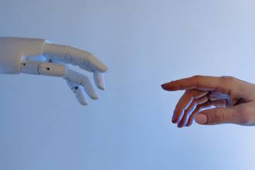 Human hand reaching out to robot hand
