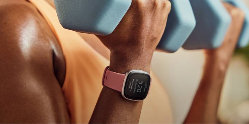 Person exercising while wearing a Fitbit Versa 4 smartwatch