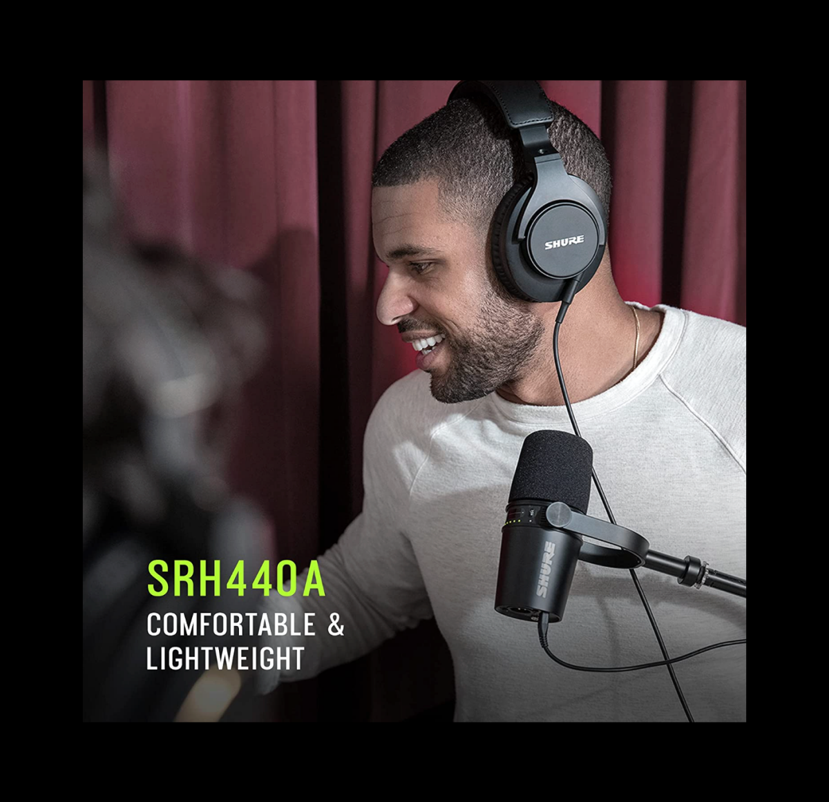 A man in the studio wearing a pair of Shure SRH440A headphones.