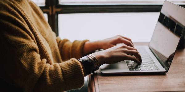 Photo of a person working on their laptop