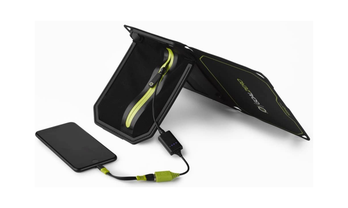 A Goal Zero Nomad 7 Plus Portable Solar Charger on its kickstand charging a smartphone