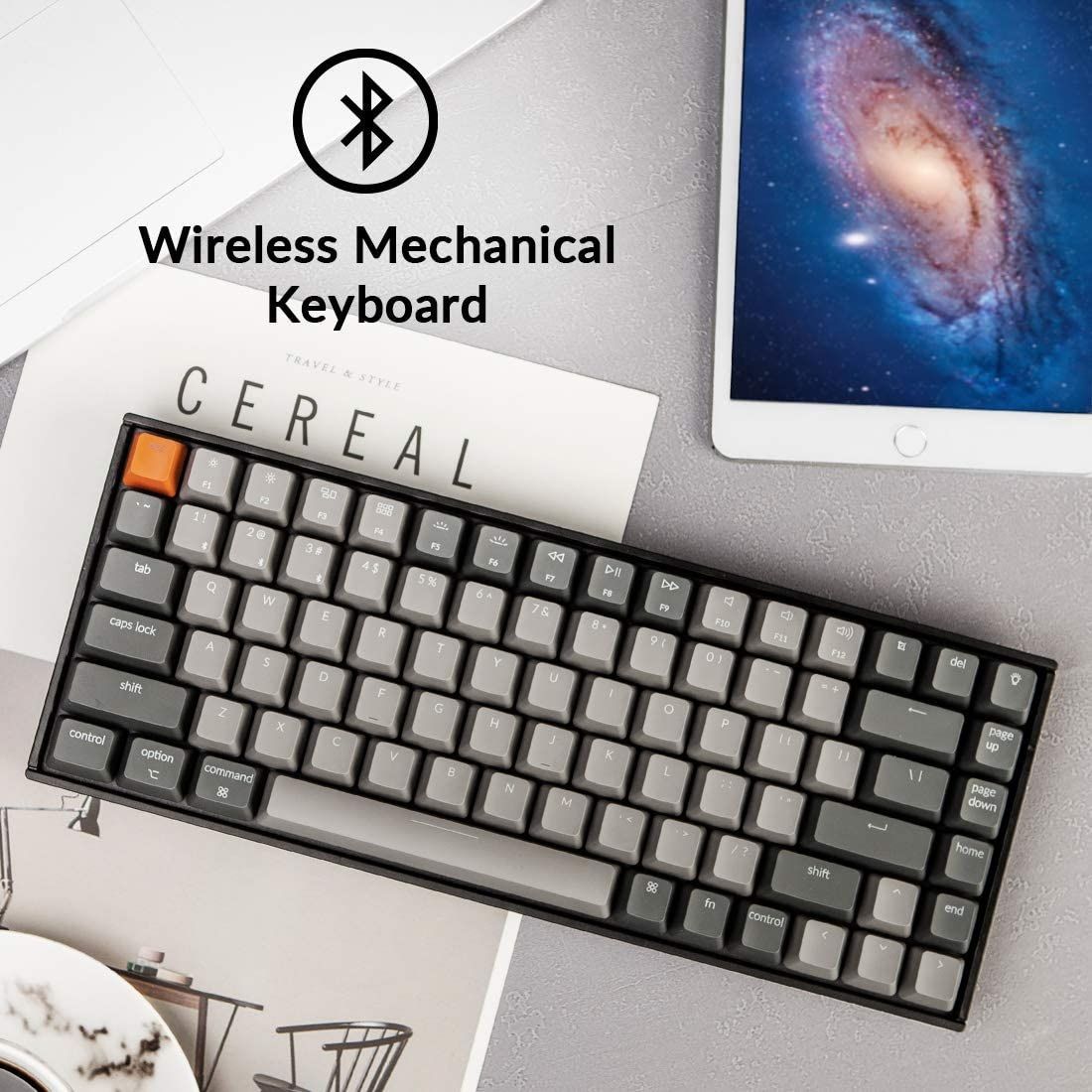 the keychron k2 mechanical bluetooth keyboard next to a tablet
