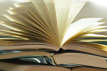 Pile of books with open pages