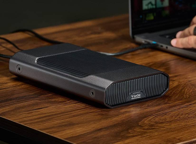 the sandisk professional g-drive external hard drive atop a desk