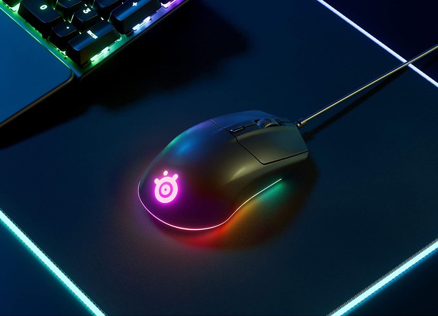 steelseries rival 3 gaming mouse placed on an rgb mousepad