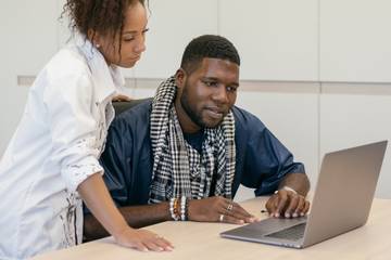 two people working together on laptop