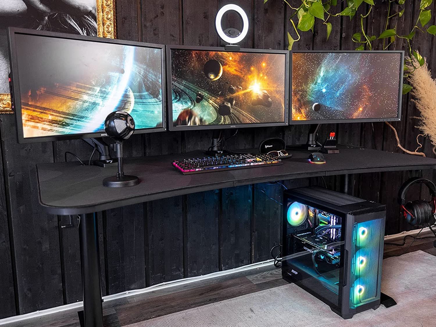 arozzi arena ultrawide curved desk with a gaming pc and three monitors