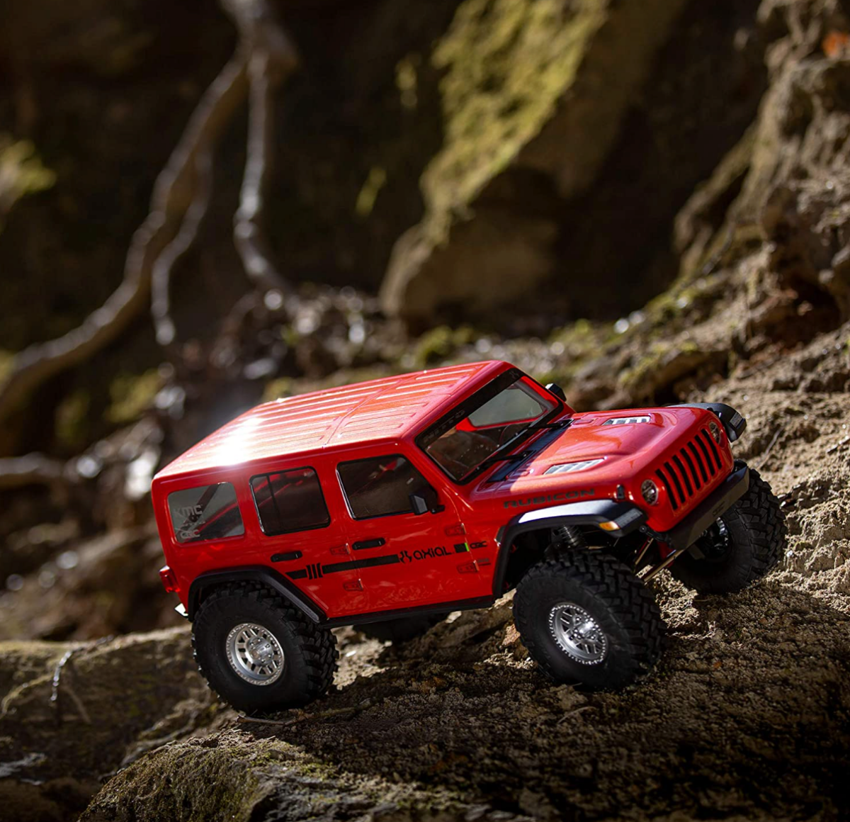 An Axial SCX10 III 1/10 Jeep JLU Wrangler in action on rugged terrain